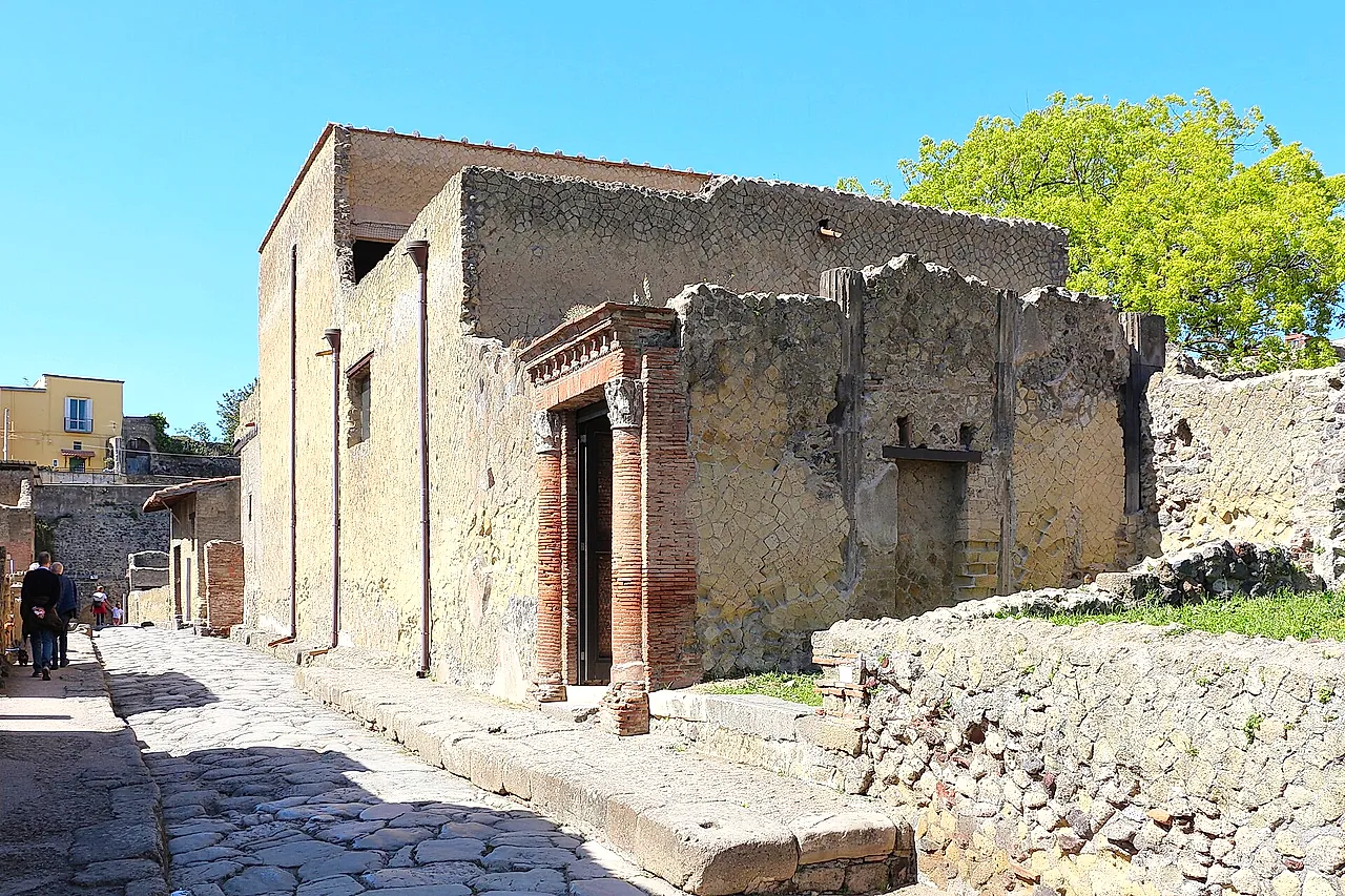 A paved street and the brick-columned doorway of the House of the Great Portal