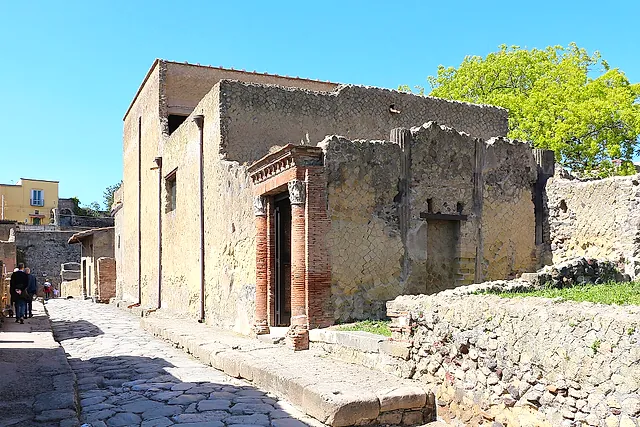 A paved street and the brick-columned doorway of the House of the Great Portal