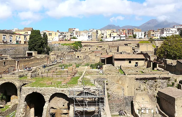 The excavated town of Herculaneum with the boathouse arches and Vesuvius beyond